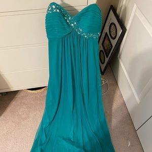 Formal teal colored, floor length dress with a slit on one side.